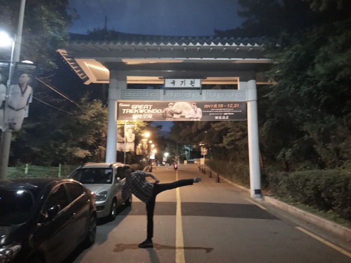 At the famous Kukkiwon gate — entrance to the Kukkiwon, World Taekwondo Headquarters